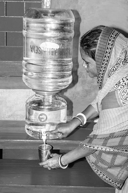 Ganga Sutradhar – consuming Sulabh safe drinking water at home in Mirzapur village, Birbhum district, West Bengal